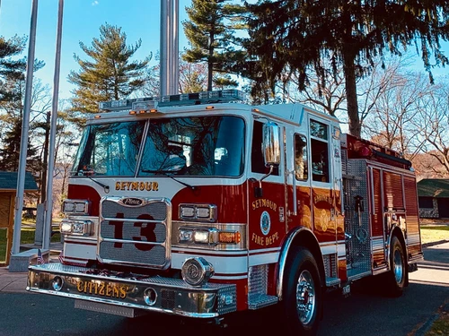 Pumper front-left exterior view showing enclosed cab and side body