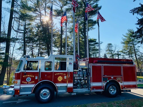 Driver-side profile view showing pumper body and rear wheel area
