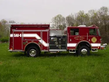 Driver-side profile view showing pump panel area and side body compartments