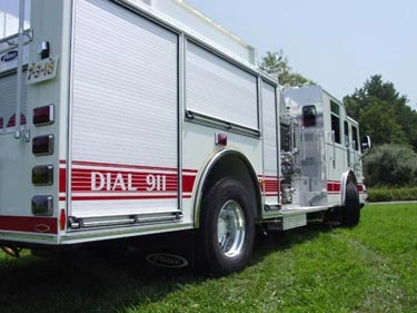 Rear-left exterior view showing tank body side panels and rear wheel area