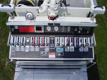 Rear control panel close-up showing gauges, valves, and labeled pump controls