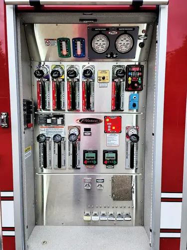 Open side compartment showing hand tools arranged in vertical rack