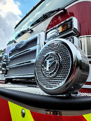 Front bumper corner close-up showing grille detail and warning light