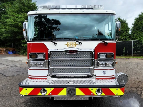 Head-on front view showing grille, bumper, and warning lights