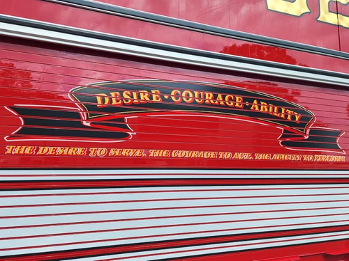Body side close-up showing decorative script on red roll-up door