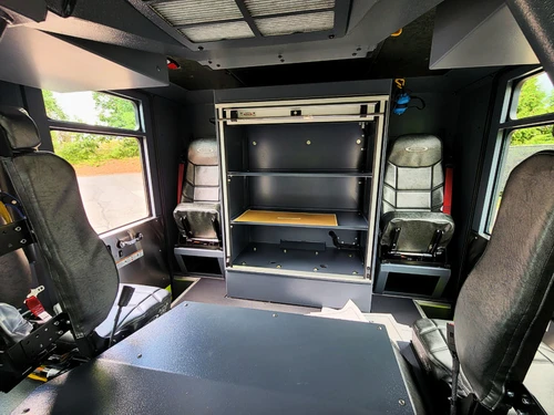 Cab interior side view showing rear seat area and storage shelves