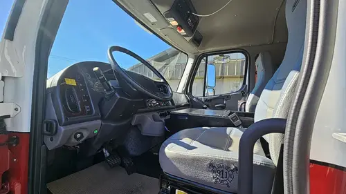 Driver cockpit view showing steering wheel, dashboard, and center controls