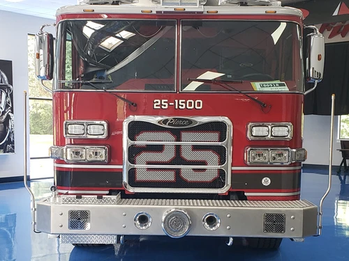 Front exterior view indoors showing grille, bumper, and warning lights