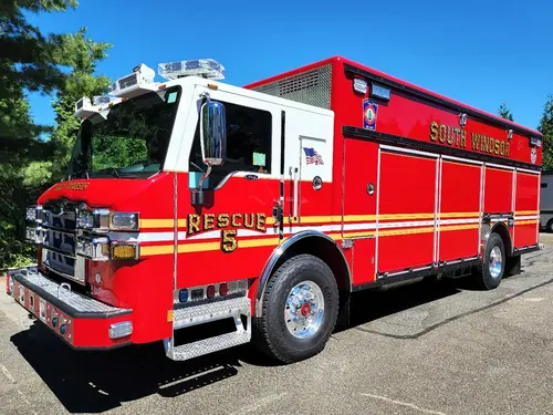 Heavy rescue truck front-left exterior view showing enclosed cab and side body