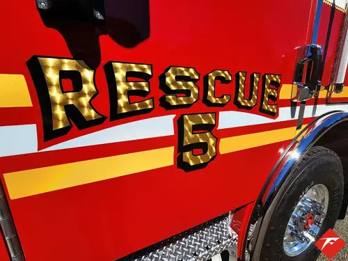Body side close-up showing raised rescue unit lettering and striping