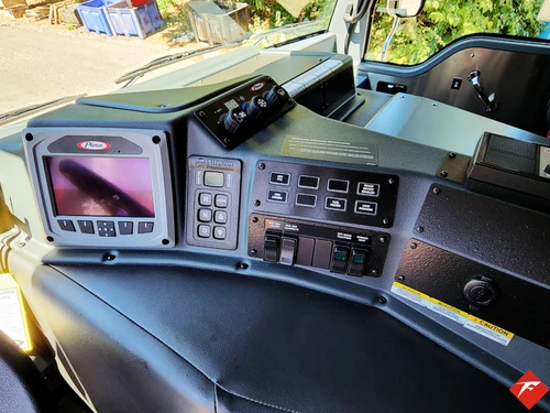 Dashboard close-up showing display screens, control panel, and radio interface