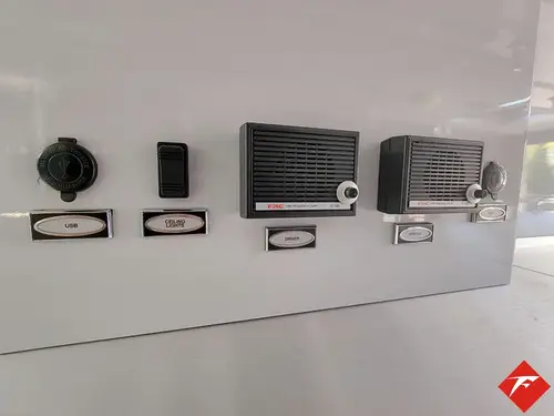 Interior wall close-up showing labeled control buttons and intercom panel