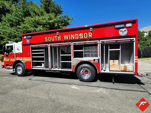 Driver-side profile with open compartments showing full rescue body layout
