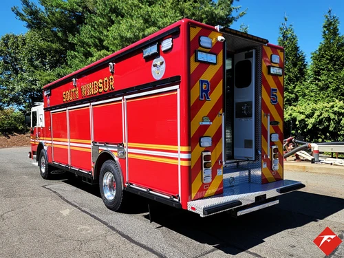 Rear-left exterior view showing rescue body and rear chevron panel