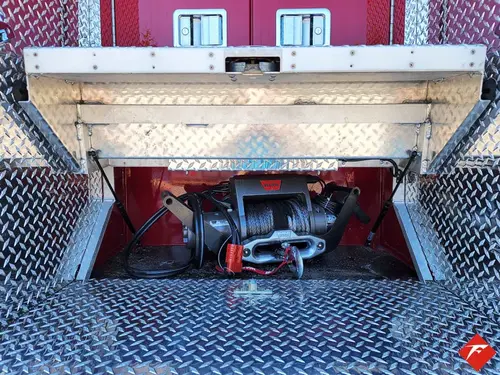 Open lower compartment showing slide-out tray with mounted rescue tools