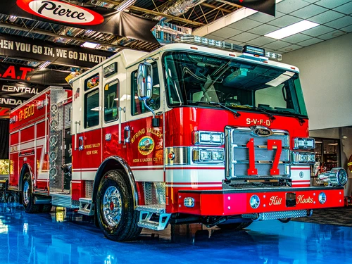 Pumper front-left exterior view indoors showing bumper, cab, and side compartments