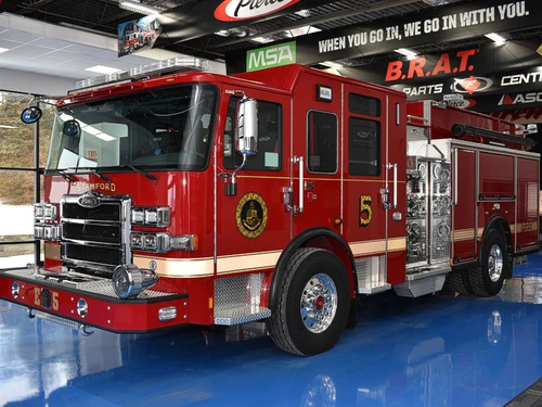 Pumper front-left exterior view showing grille, bumper, and enclosed cab