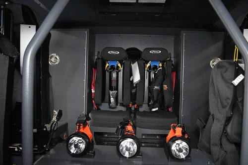 Open cab console area showing mounted radios and cup-holder mounts