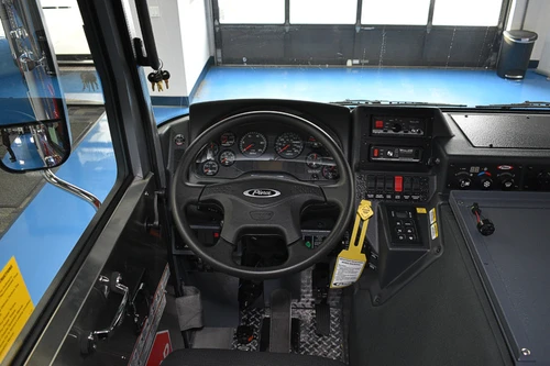 Driver cockpit view showing steering wheel, dashboard, and center controls