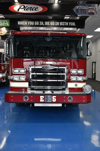 Head-on front view showing grille, bumper intake, and warning lights