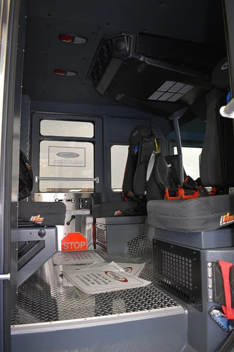 Rear crew interior view showing seat backs and aisle through the cab