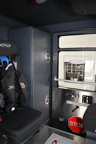 Rear crew area view showing seat mount and cabinet panel