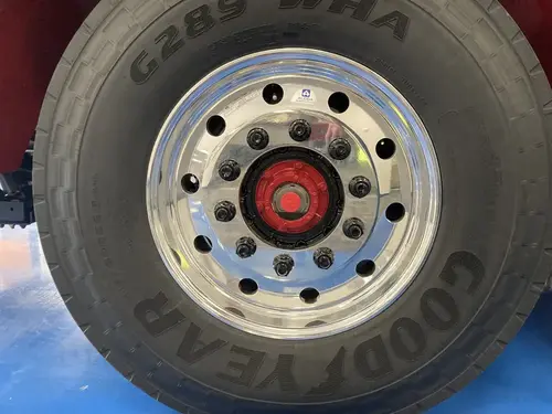 Front wheel close-up showing rim hardware and tire sidewall