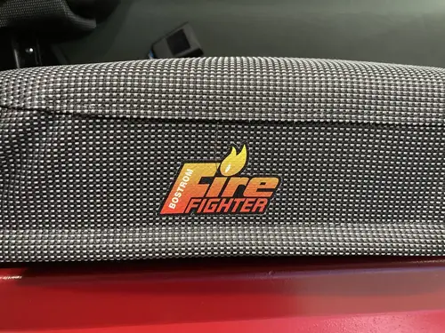 Seatback close-up showing Fire Fighter text on dark fabric