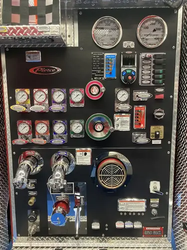 Pump panel close-up showing gauges, valves, and intake controls