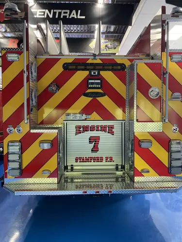 Rear view showing red-and-yellow chevrons and centered unit panel