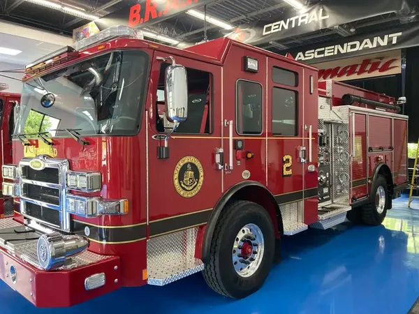 Pumper front-left exterior view showing enclosed cab and side body