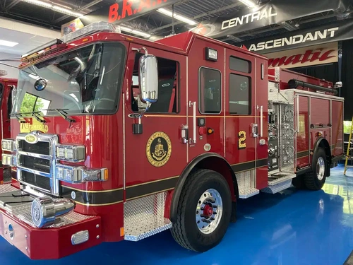 Pumper front-left exterior view showing enclosed cab and side body
