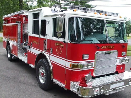 Pumper front-left exterior view showing enclosed cab and side compartments