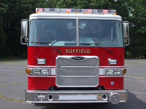 Head-on front view showing grille, bumper, and roof warning light bar