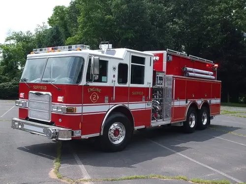 Front-right exterior view showing cab, pump panel area, and tandem rear wheels