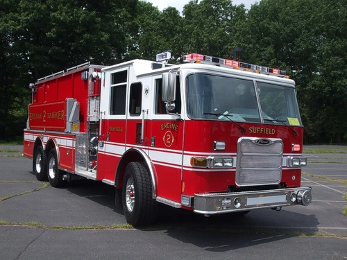 Front-right exterior view showing chrome bumper, grille, and cab door emblems