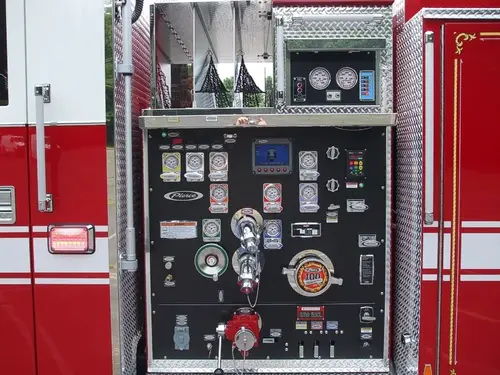 Pump panel close-up showing gauges, intake controls, and discharge valves
