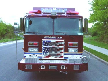 Front exterior view showing grille, bumper, and warning lights