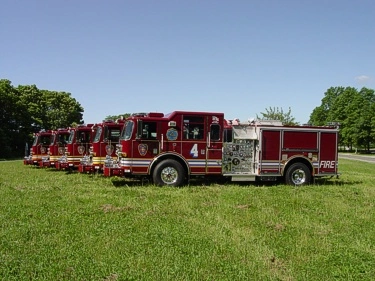 Wide lineup side view showing multiple pumpers parked in a row