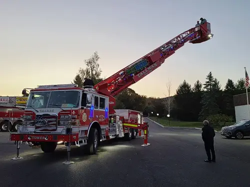 Evening exterior view showing tower ladder with aerial raised