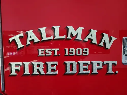 Body side close-up showing raised department script on red paint