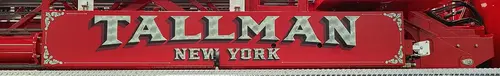 Body side lettering close-up strip showing Tallman New York script