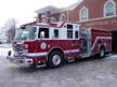 Front-left exterior view showing cab, bumper, and side compartments