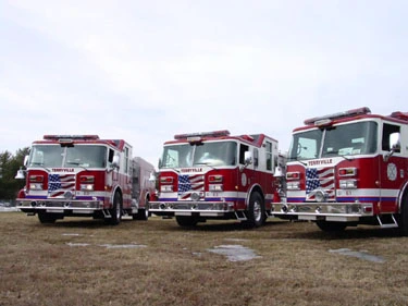 Three-quarter lineup view showing multiple pumper front ends and side compartments