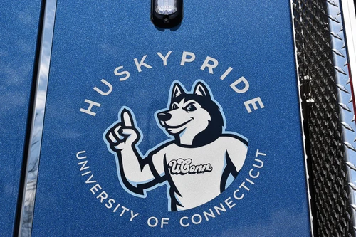 Cab door close-up showing circular mascot decal and blue door panel