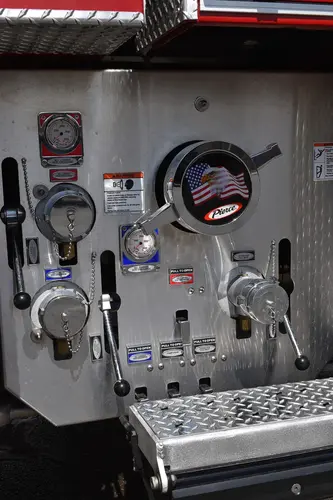 Pump panel close-up showing gauges, valves, and intake connections