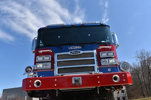Head-on front view showing grille, bumper, and warning lights