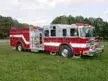Pumper front-left exterior view showing enclosed cab and side compartments