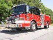 Wide front-left thumbnail view of the pumper parked roadside with full side body visible.