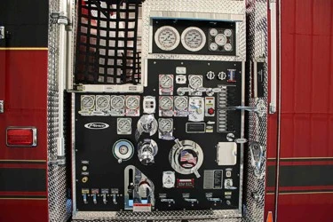 Close-up of the pump panel with gauges, valves, intake controls, and switch bank.